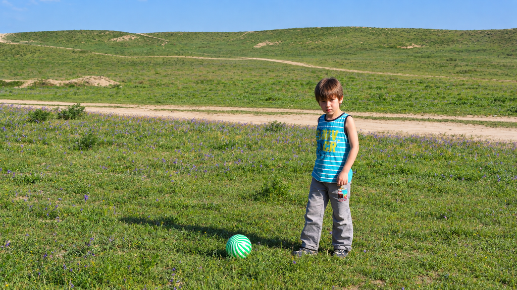 Child with a football on a grass field, where it all started