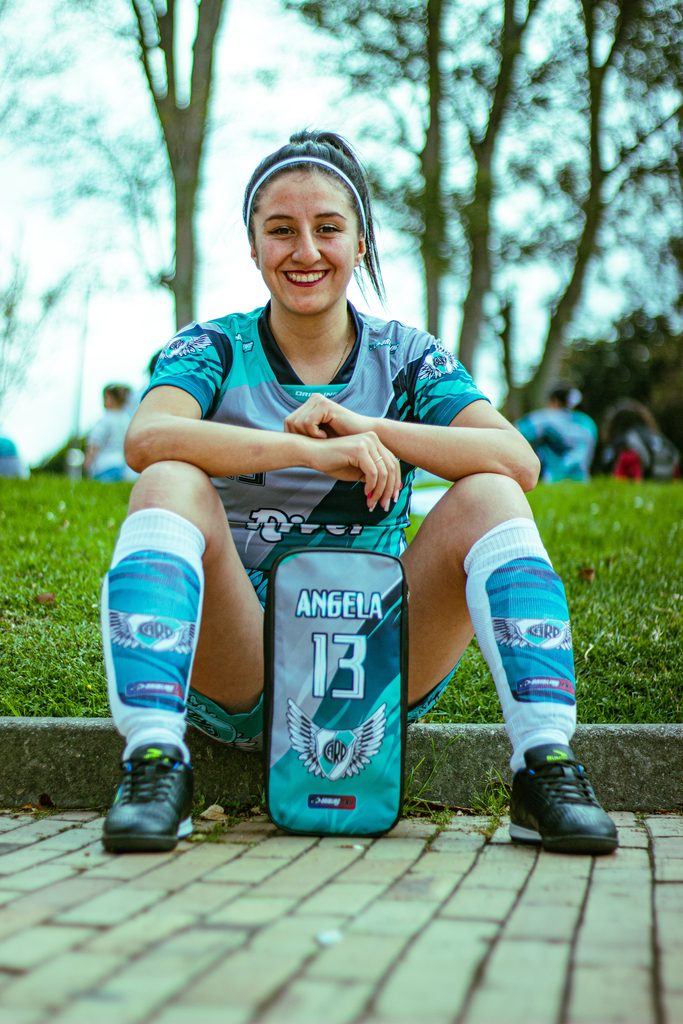 Player sitting on the grass wearing shin guards